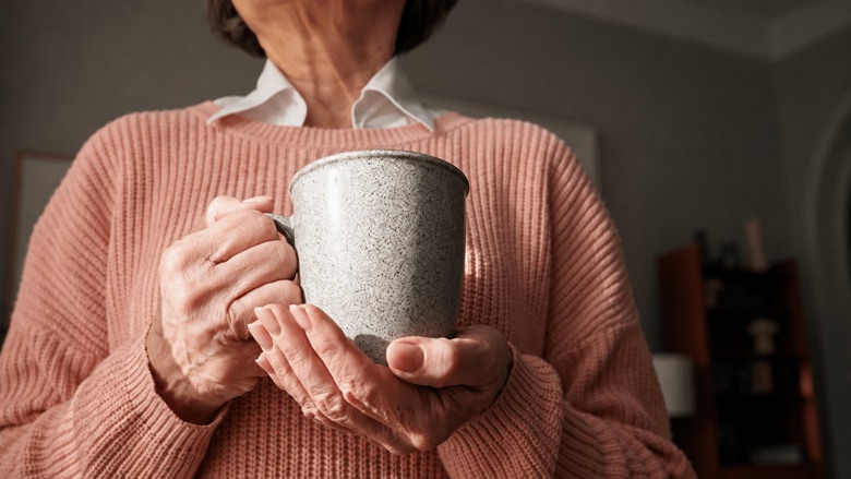 Woman holding a warm cup during a quiet morning routine